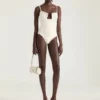 Body con aberturas en punto y perlas bordadas Body con aberturas en punto y perlas bordadas