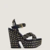 Sandalias de plataforma tipo zueco de cuero con tachuelas